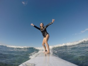 Double shaka woman surfing